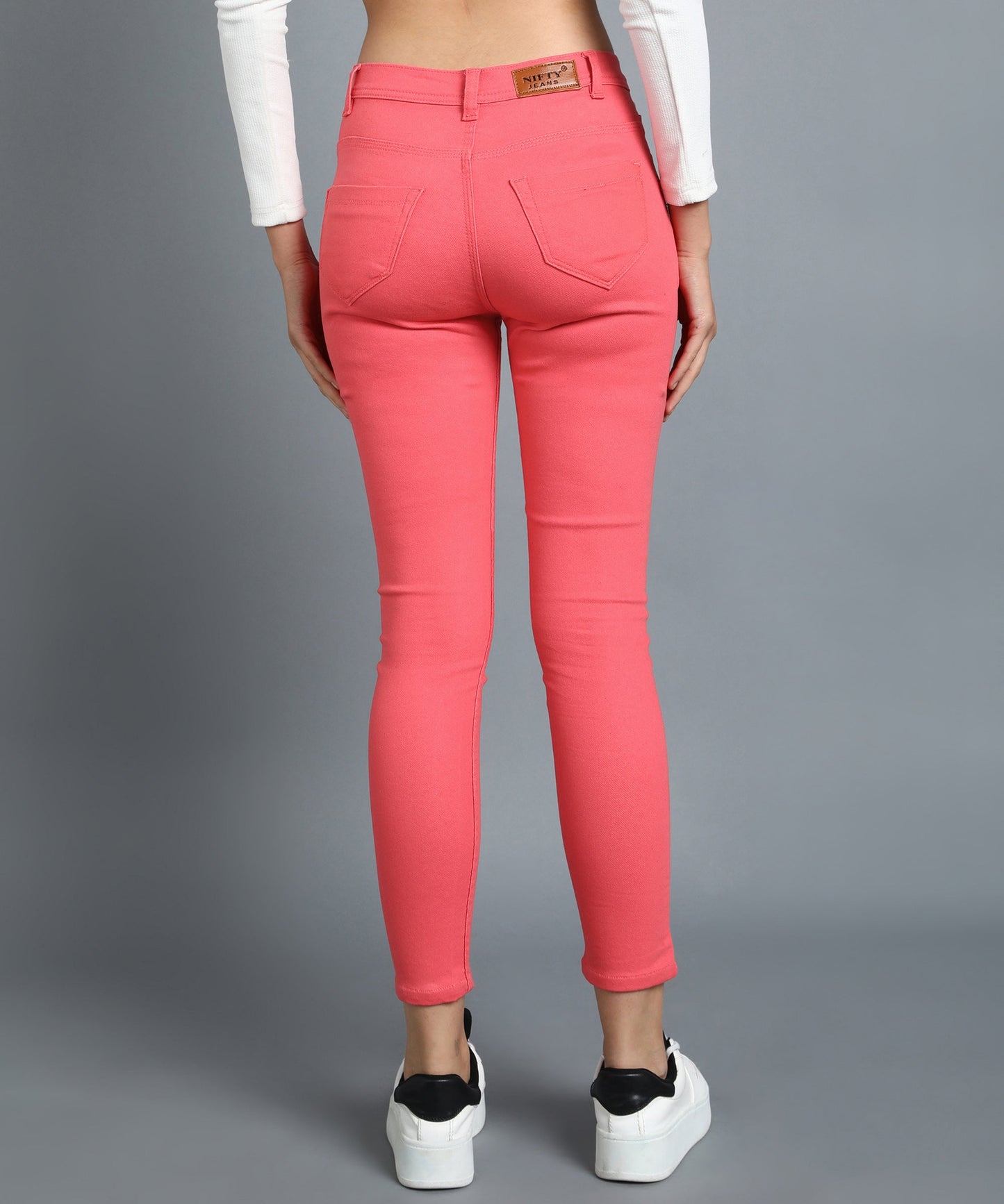 Red slim fit 5- pocket high rise jeans, clean look, zip fly with button closure, waistband with belt loops